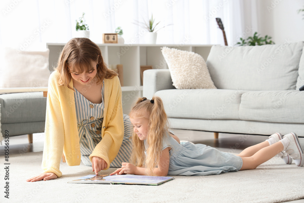 Sticker nanny with little girl reading book on floor at home