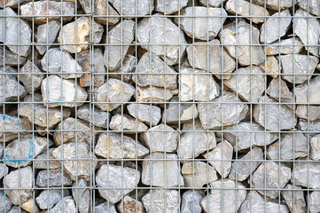 Rough textured wall with nature stones and a metal wired frame, Koekelberg, Belgium