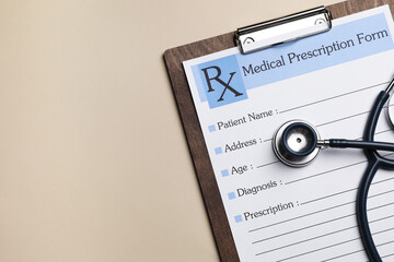 Clipboard with medical prescription form and stethoscope on beige background, flat lay. Space for text