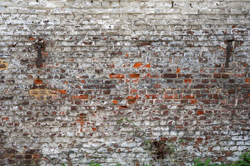 Dirty brick stone wall with mortar layers, textured background in Belgium