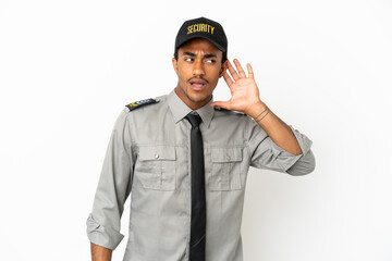 African American safeguard over isolated white background listening to something by putting hand on the ear