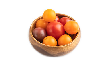 Red. yellow tomatoes in wooden bowl isolated on white. Side view.