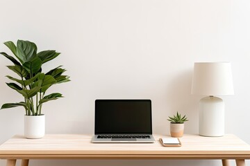 A minimalist workspace featuring a laptop with a black screen, a desk lamp, a vase with white flowers, books, and stationery on a wooden desk against a light beige wall.