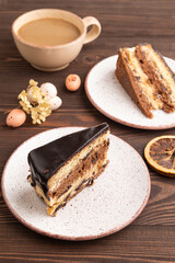 Chocolate biscuit cake with caramel cream on brown wooden. side view