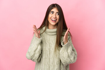 Young caucasian woman isolated on pink background with surprise facial expression