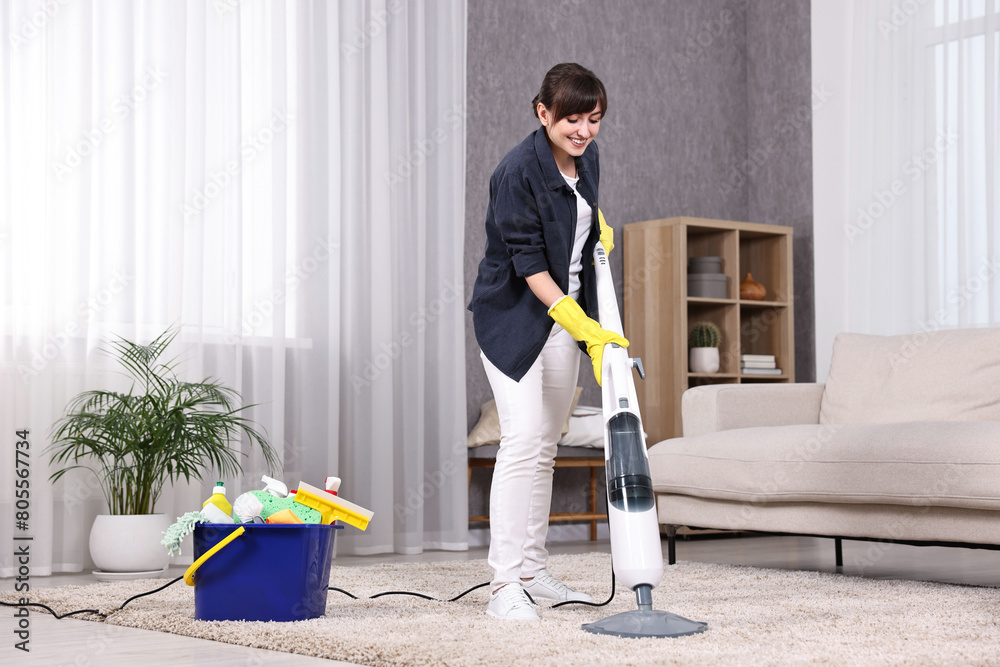 Sticker Happy young housewife vacuuming carpet at home