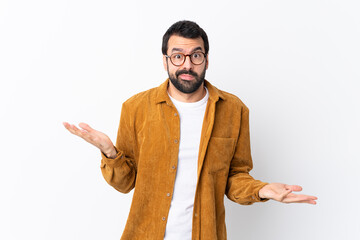 Caucasian handsome man with beard wearing a corduroy jacket over isolated white background unhappy for not understand something