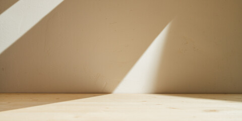 Wooden table mockup on stucco background with branch shadows on the wall. Mock up for branding products, presentation and health care.  © mallmo