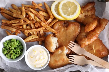 Tasty fish, chips, sauce and peas on tray, top view