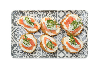 Tasty canapes with salmon, cucumber, cream cheese and dill isolated on white, top view