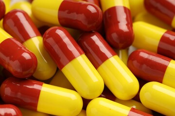 Many antibiotic pills as background, closeup. Medicinal treatment