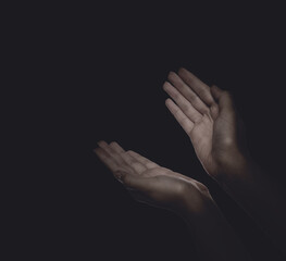 Christian woman praying in darkness, closeup. Space for text