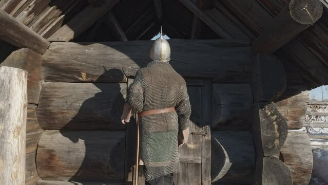Giant epic hero in russian folklore coming to the wooden izba. Media. The plot of the old russian story.