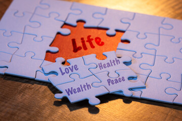 Concept for the four pillars of life using a puzzle with a red placer where the last piece belongs.