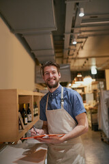 Man, clipboard and inventory on shelf in restaurant for alcohol, wine and management for stock. Male cafe owner, paperwork and sale for small business, pub and entrepreneur in service industry
