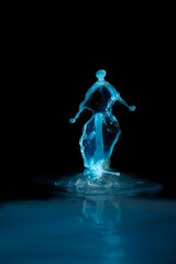 drops of colored water falling, colliding with each other forming figures