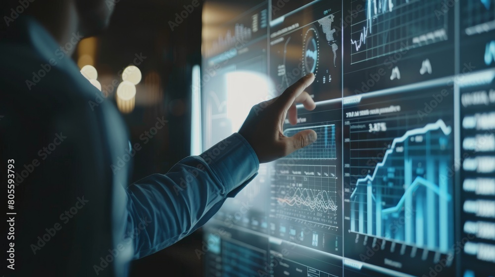 Wall mural businessman is touching a virtual screen displaying business data and analytics on a digital display