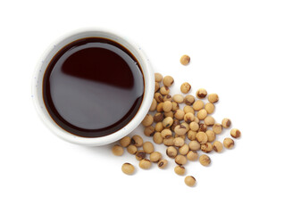 Tasty soy sauce in bowl and soybeans isolated on white, top view