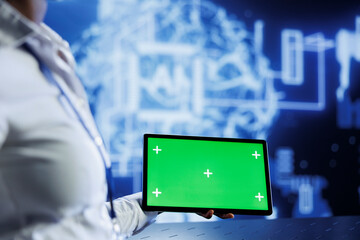 Admin uses green screen tablet to develop artificial intelligence neural networks nodes modeled...