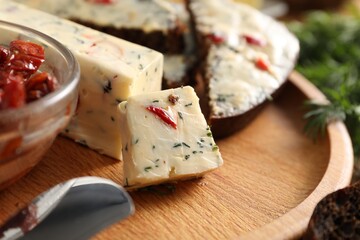 Tasty butter with dill and chili pepper on wooden plate, closeup