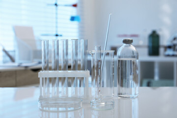 Laboratory analysis. Different glassware on white table indoors