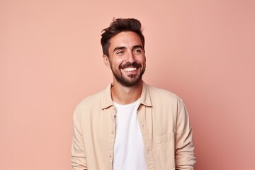 Obraz premium A man with a big smile on his face is wearing a white shirt and a tan shirt