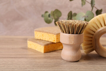Small cleaning brush on wooden table, closeup. Space for text