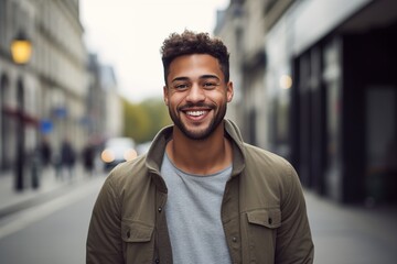 Fototapeta premium A man with a beard and a green jacket is smiling
