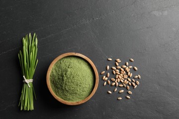 Wheat grass powder in bowl, seeds and fresh sprouts on grey textured table, flat lay