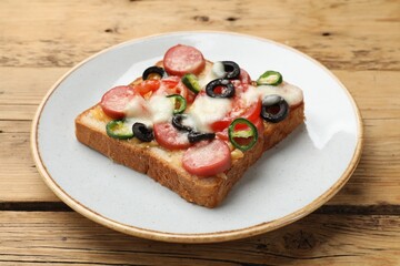Tasty pizza toast on wooden table, closeup