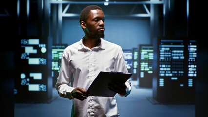 African american engineer doing maintenance in data center providing vast computing resources and...