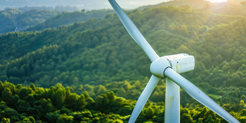 Close up of white wind turbine with lush forest trees in the background, copy space.