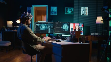 Engineer with EEG headset inserting cartridge into PC to use high tech software allowing for brain transfer into virtual world. Man putting disk in computer to start consciousness upload, camera B