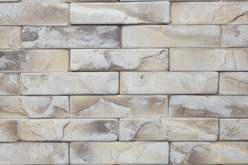 A brick wall with a white and brown color