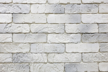 A wall made of white bricks with a greyish tint