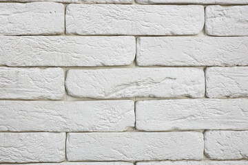 A white brick wall with rough texture