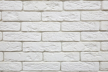 A white brick wall with rough texture