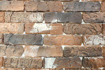 A brick wall with white paint on it