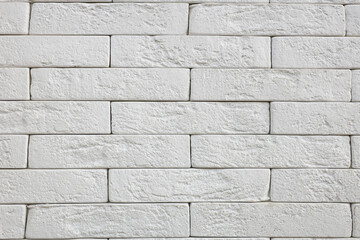 A white brick wall with a rough texture