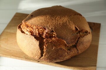 Freshly baked sourdough bread on white table