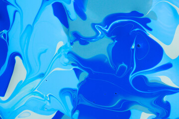 Mixed blue nail polishes as background, top view