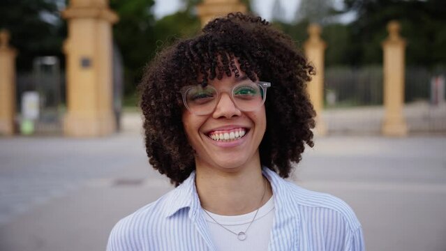 Close up head shot beautiful Latin American teen school girl single happy looking at camera. Wide and charming smile natural outdoor poses. Gen Z portrait concept. Cheerful young people. 