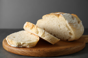 Freshly baked cut sourdough bread on grey table, closeup