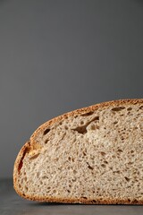 Piece of freshly baked sourdough bread on grey table