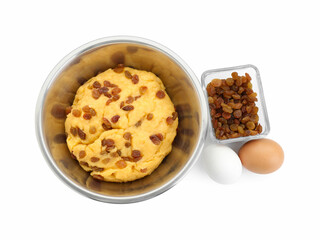 Dough with raisins in bowl and eggs isolated on white, top view