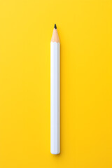 Template with copy space by top view closeup macro photo of wooden yellow pencil put on yellow paper that look minimal and clean. Side flash light made difference between them by highlight and shadow.