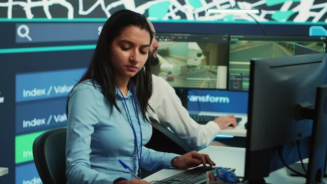 Indian employee collecting and transmitting information to couriers, locating the destination and sending the gps coordinates for faster order delivery. Dispatch call center operator. Camera A.