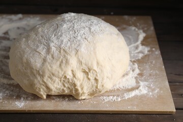 Raw homemade dough on wooden table, closeup