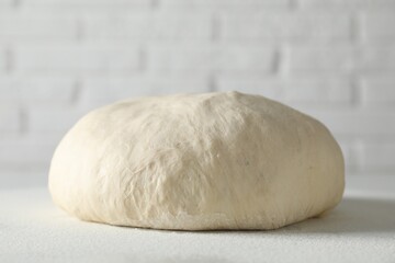 Fresh raw homemade dough on light table