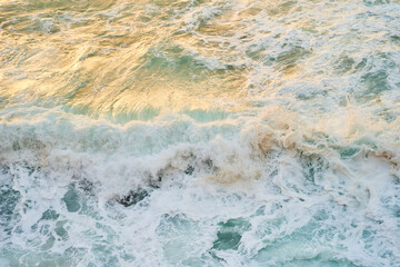 A closeup shot of the ocean with wind waves crashing onto the shore, creating a beautiful pattern...